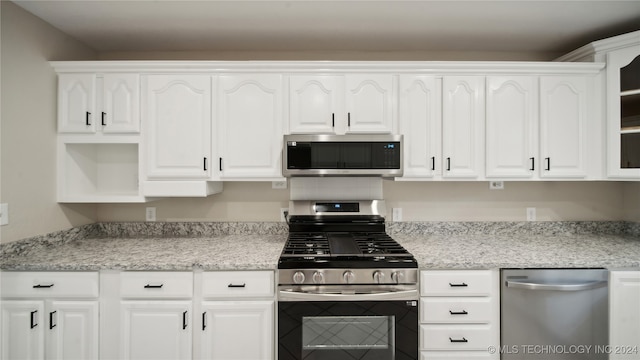 kitchen with appliances with stainless steel finishes and white cabinets