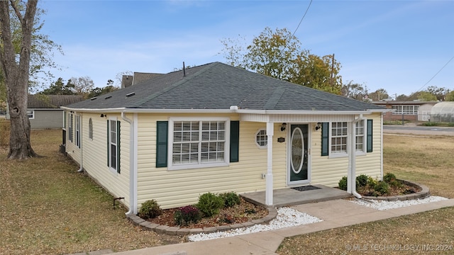 bungalow-style home with a front yard