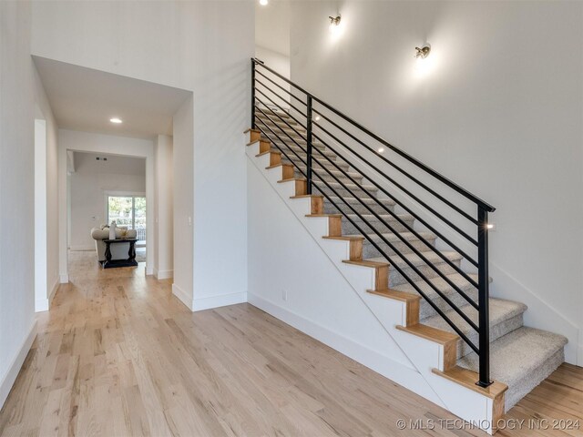 staircase with wood-type flooring