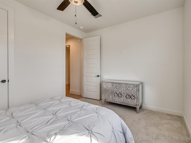 carpeted bedroom featuring visible vents, ceiling fan, and baseboards