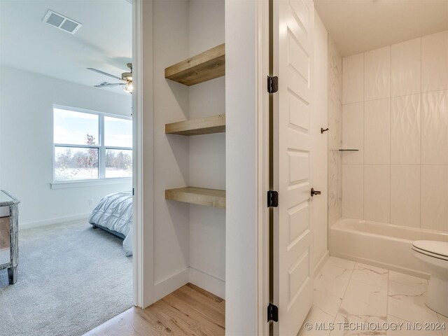 bathroom with toilet and ceiling fan