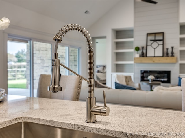 interior space featuring light stone counters and built in shelves