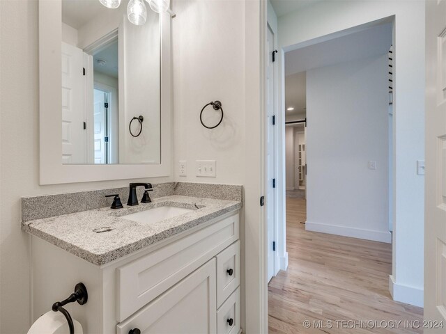 bathroom featuring vanity and hardwood / wood-style floors