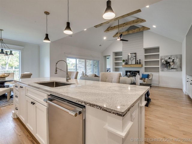 kitchen with an island with sink, dishwasher, light wood-style flooring, and a sink