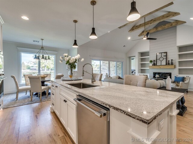 kitchen featuring white cabinets, hanging light fixtures, sink, lofted ceiling with beams, and stainless steel appliances