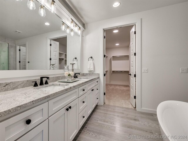 bathroom featuring vanity, hardwood / wood-style flooring, and independent shower and bath