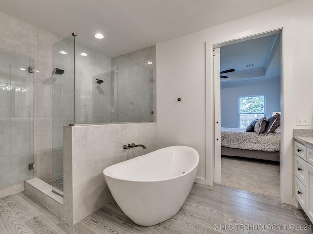 ensuite bathroom featuring recessed lighting, a soaking tub, connected bathroom, a shower stall, and vanity