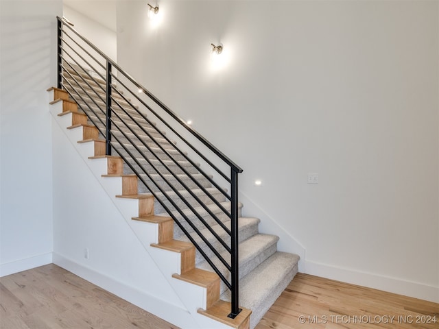 stairs with hardwood / wood-style flooring