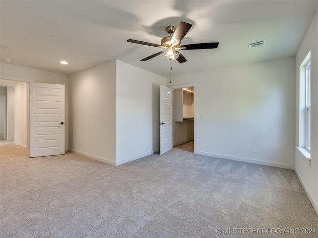 unfurnished bedroom with light colored carpet, visible vents, baseboards, and recessed lighting