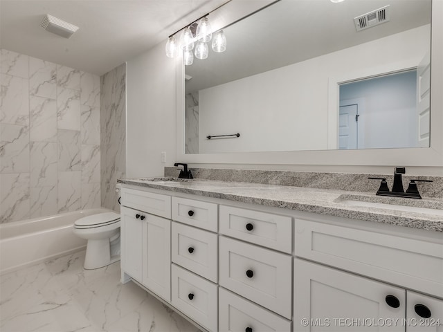 full bathroom with vanity, toilet, and tiled shower / bath combo