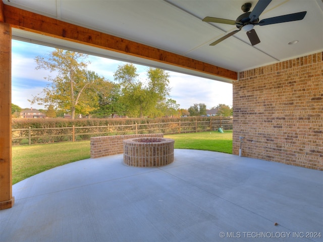 view of patio / terrace with a fire pit and ceiling fan