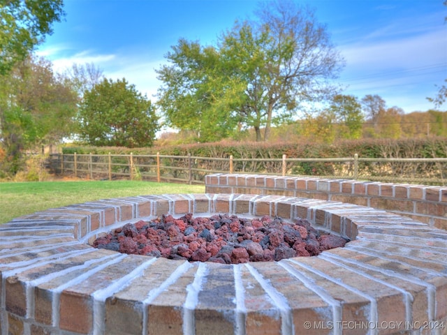 exterior space with an outdoor fire pit and fence