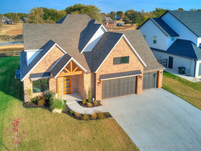 view of front of home with a front yard and a garage