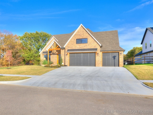 view of front facade featuring a front yard and a garage