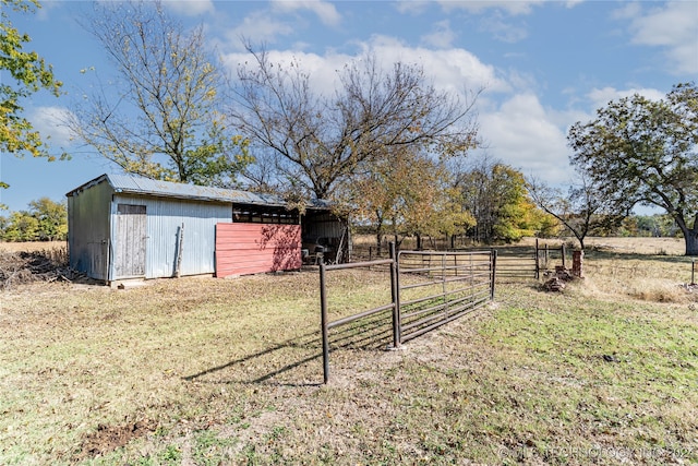 view of yard with a rural view and an outbuilding