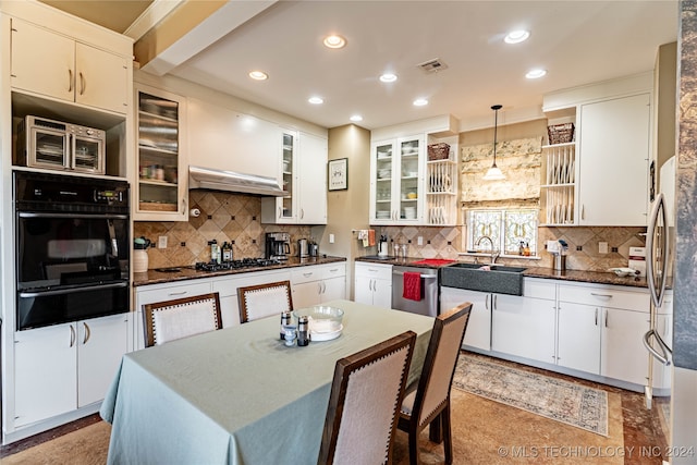 kitchen featuring gas stovetop, sink, decorative light fixtures, stainless steel dishwasher, and white cabinetry