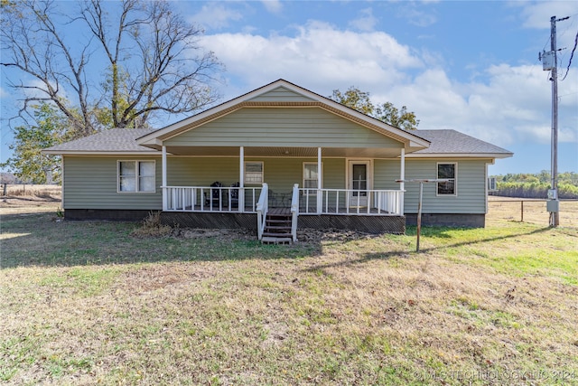 view of front of property with covered porch and a front lawn