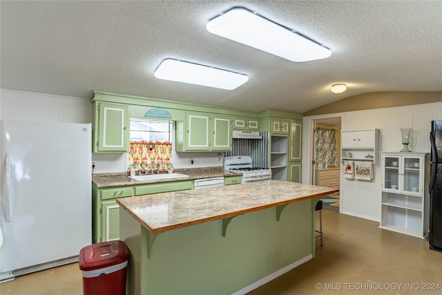 kitchen featuring a breakfast bar, vaulted ceiling, a center island, green cabinetry, and white appliances