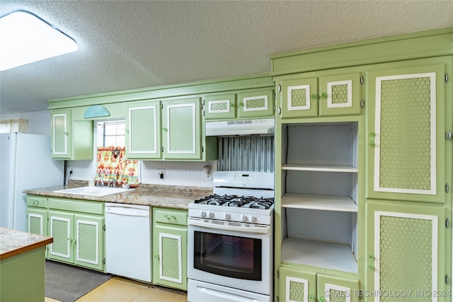 kitchen with sink, a textured ceiling, and white appliances