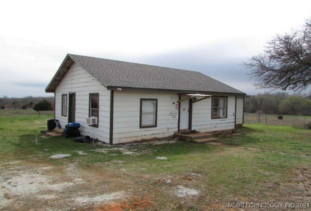 single story home with a front yard and cooling unit