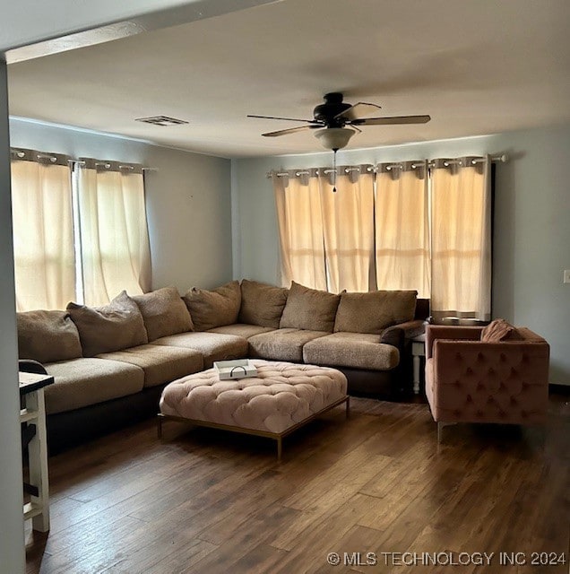 living room featuring ceiling fan and hardwood / wood-style floors