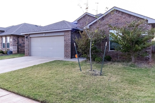 ranch-style house with a garage and a front yard