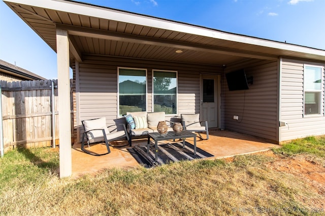 back of house with an outdoor living space and a patio