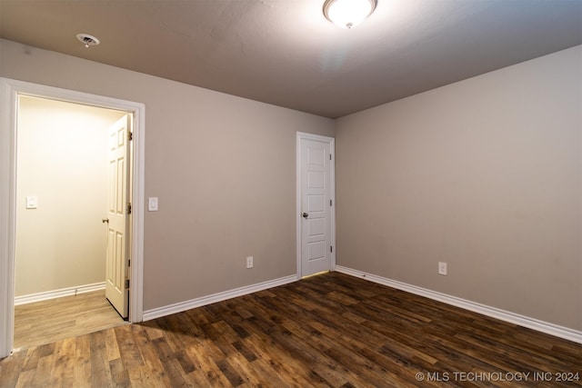 spare room with dark hardwood / wood-style flooring