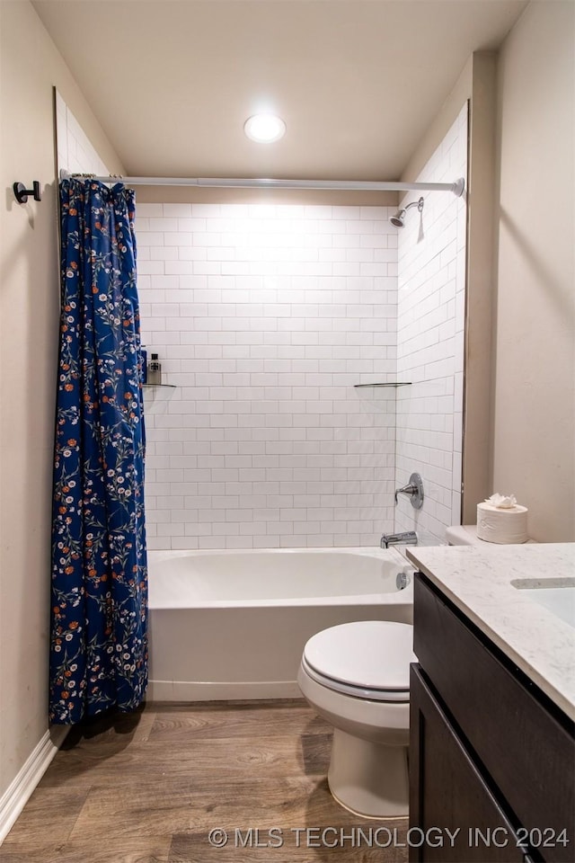 full bathroom featuring hardwood / wood-style flooring, vanity, shower / tub combo, and toilet