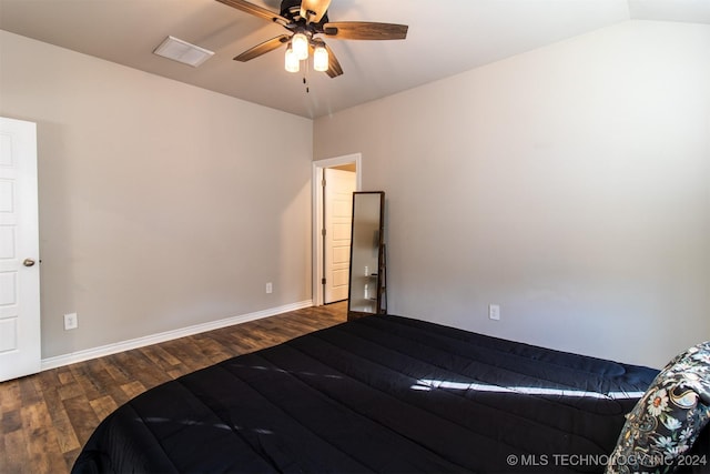 unfurnished bedroom featuring ceiling fan, dark hardwood / wood-style flooring, and vaulted ceiling