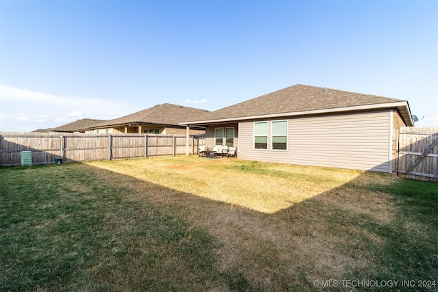 rear view of house with a yard