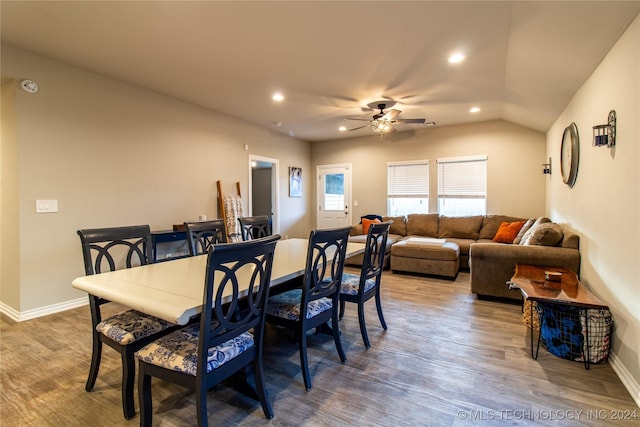 dining area with hardwood / wood-style flooring, vaulted ceiling, and ceiling fan