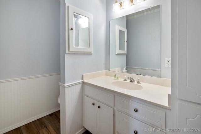 bathroom featuring vanity, toilet, and hardwood / wood-style floors