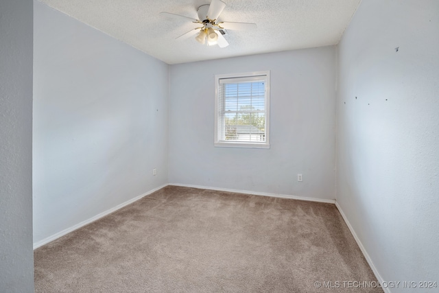 carpeted empty room with a textured ceiling and ceiling fan