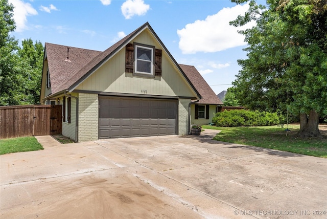 view of front of property featuring a garage and a front yard