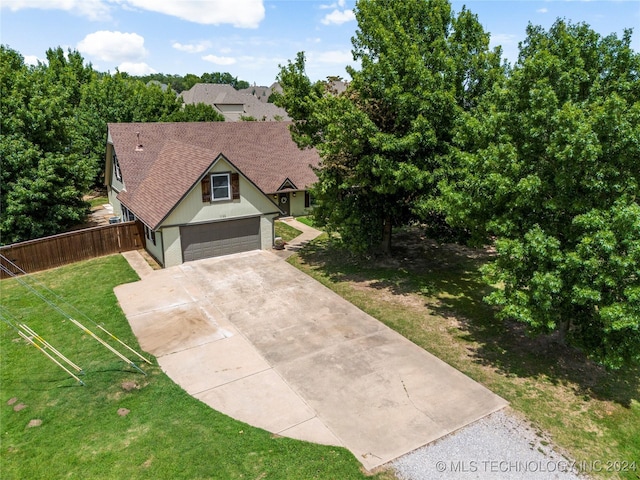 view of front of property with a front lawn and a garage