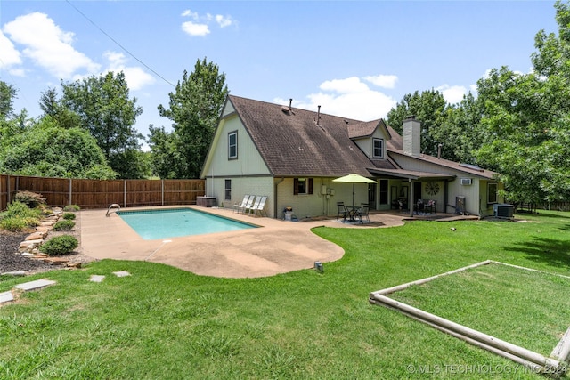 view of pool with central air condition unit, a yard, and a patio