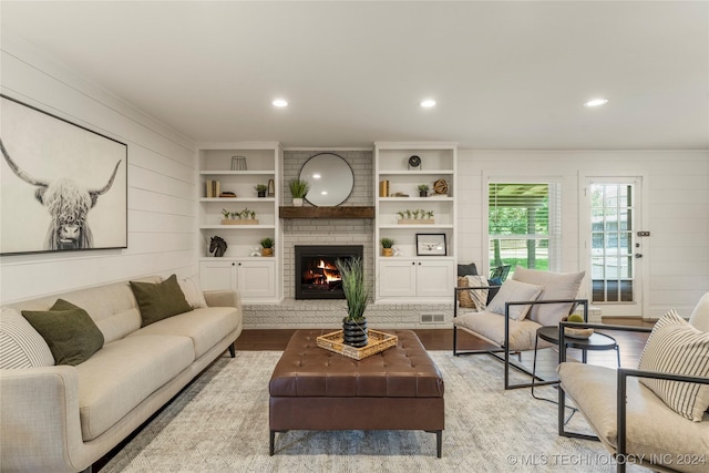 living room with light wood-type flooring and a fireplace