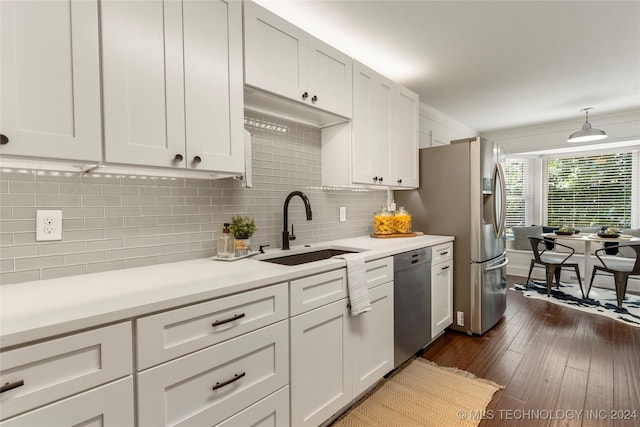 kitchen featuring white cabinets, dishwasher, sink, backsplash, and dark hardwood / wood-style floors