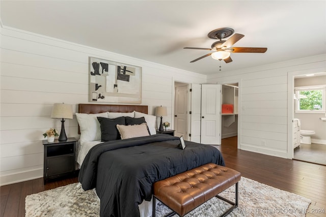 bedroom featuring ceiling fan, ensuite bathroom, and dark hardwood / wood-style floors