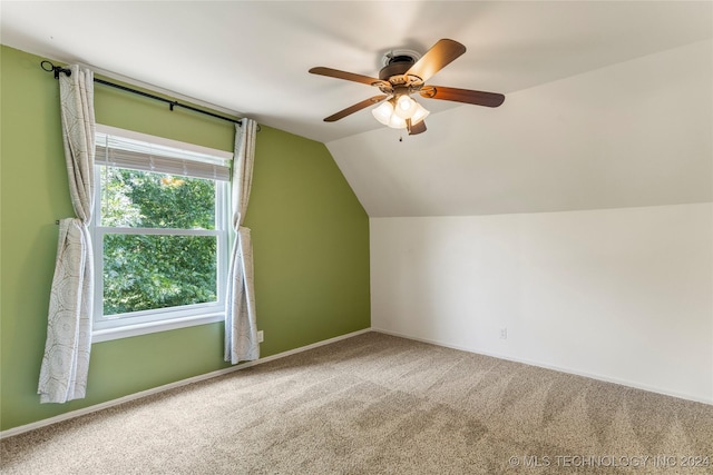 additional living space with ceiling fan, vaulted ceiling, and carpet flooring