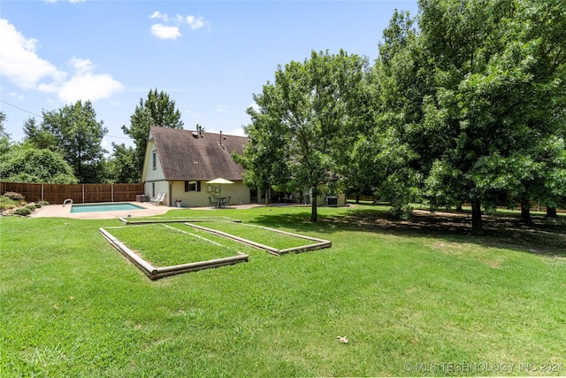 view of yard featuring a patio and a fenced in pool