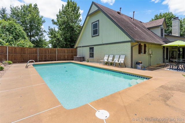 view of swimming pool with a patio