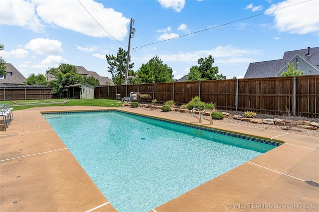 view of pool featuring a storage shed