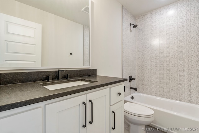 full bathroom featuring toilet, vanity, and tiled shower / bath