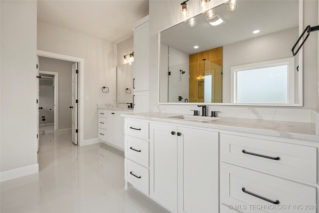 bathroom with tile patterned flooring, vanity, and a shower with shower door