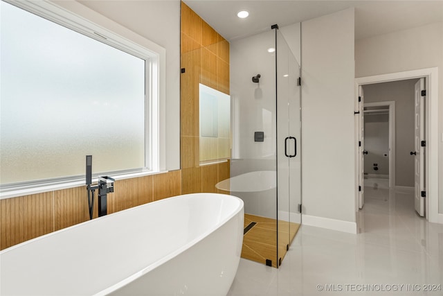 bathroom with shower with separate bathtub and tile patterned flooring