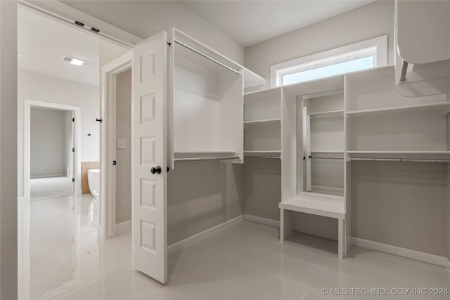 spacious closet featuring light tile patterned floors