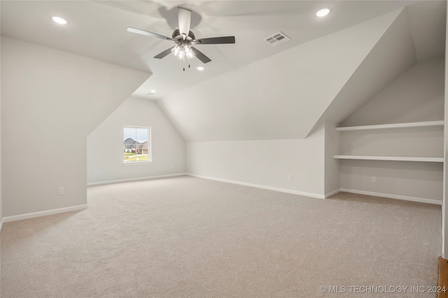 bonus room with lofted ceiling, light carpet, and ceiling fan