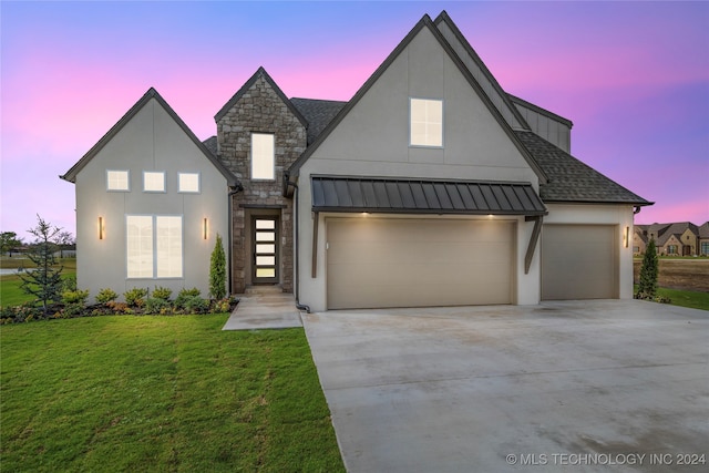 modern inspired farmhouse with a garage and a yard